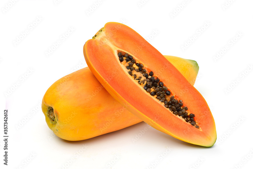 Ripe papaya fruit with cut in half isolated on white background.