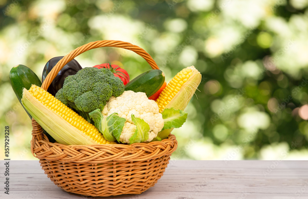 Group Healthy assorted fresh vegetable in a wooden basket, With vitamins c from salad, tomato, carro