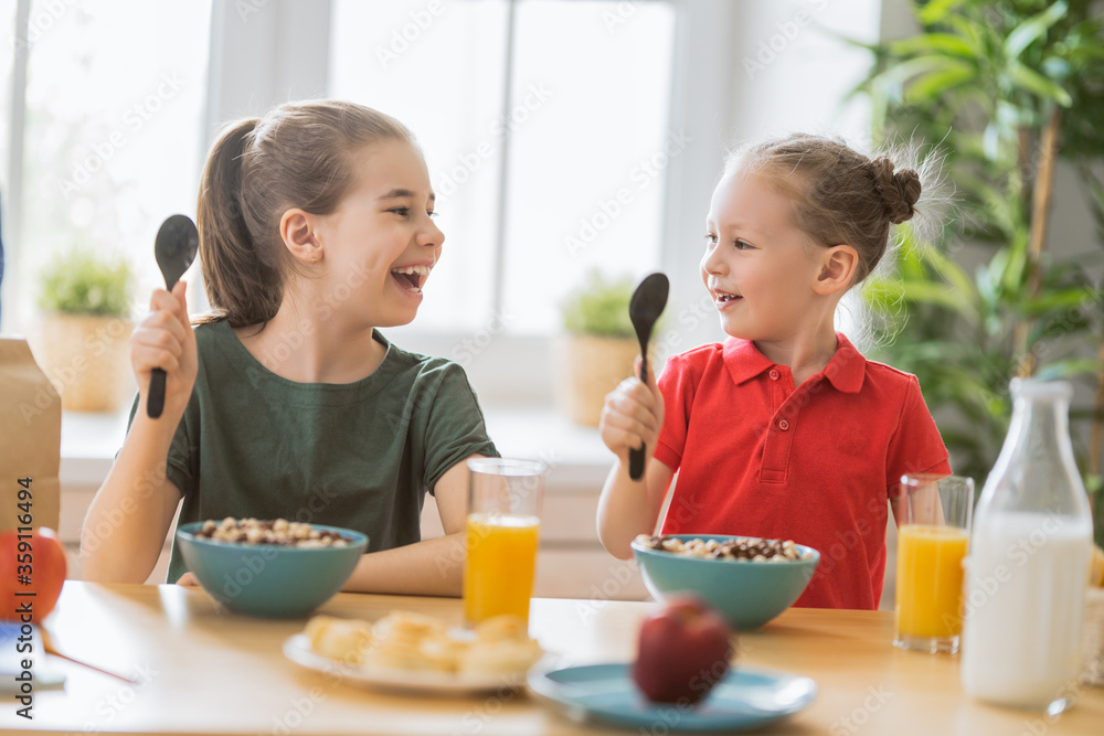 Happy children having breakfast