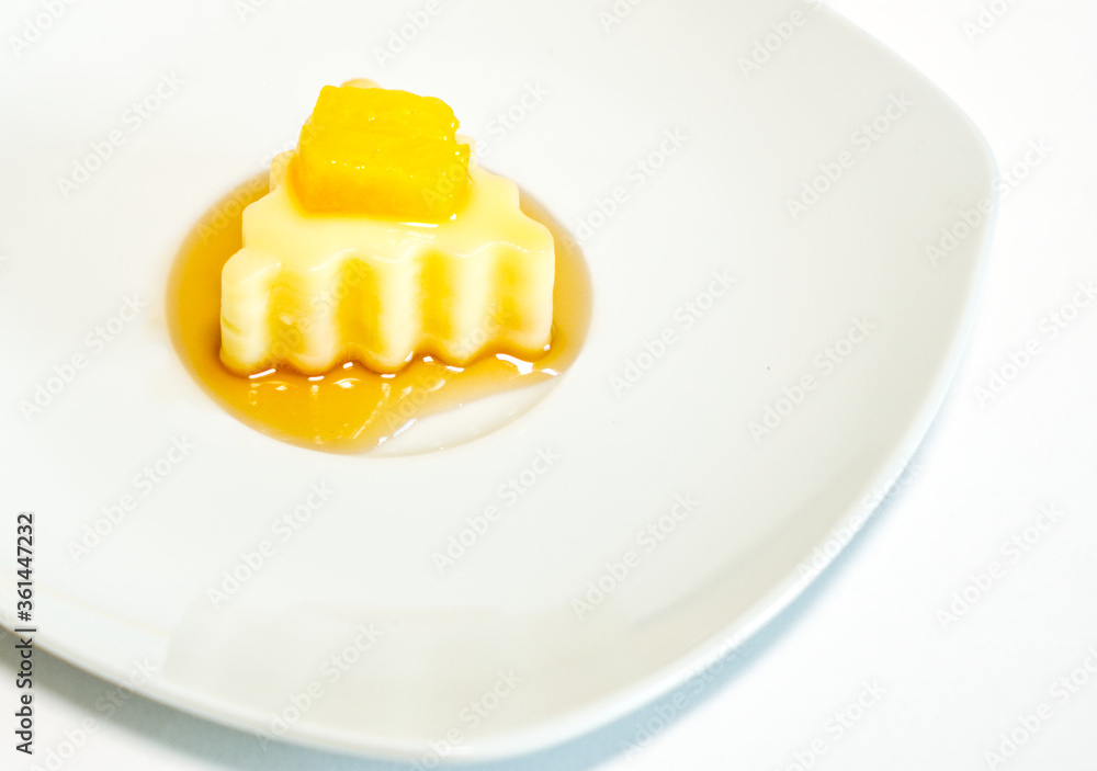 Homemade mango pudding with milk, mango mousse, dessert on white plate