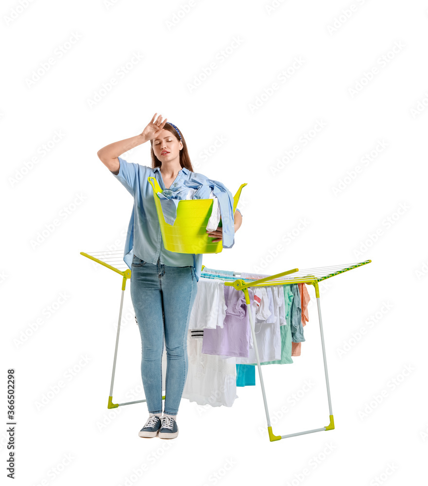 疲惫的女人，白色背景上有干净的衣服和烘干机