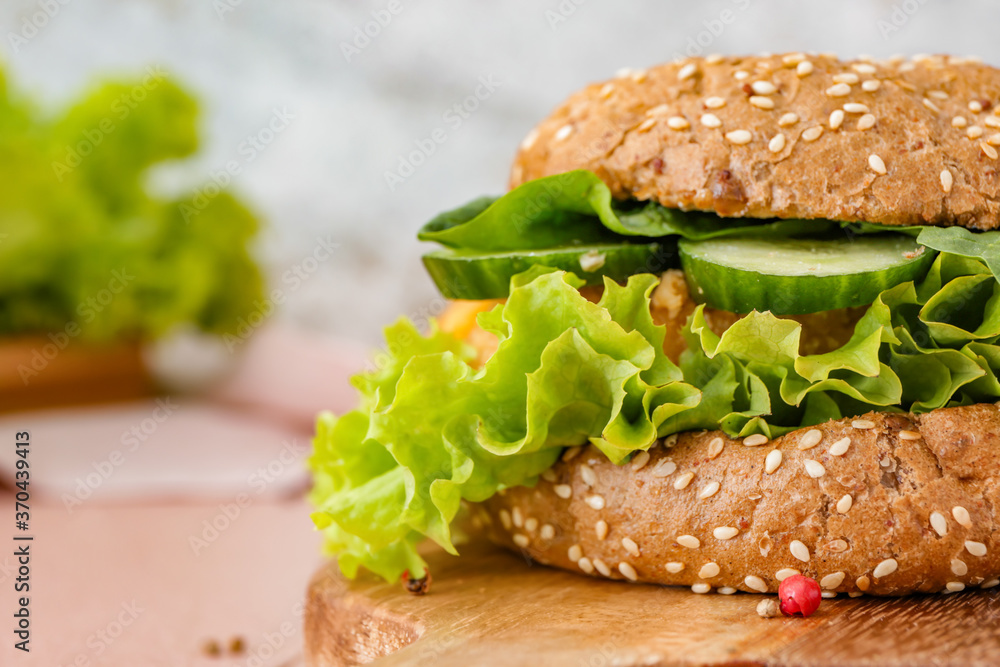 Board with tasty vegan burger on table, closeup
