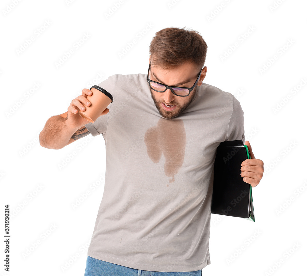 Stressed young businessman with coffee stains on his t-shirt on white background