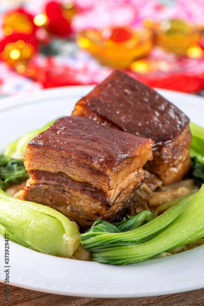 Dong Po Rou (Dongpo pork meat) in a beautiful blue plate with green broccoli vegetable, traditional 