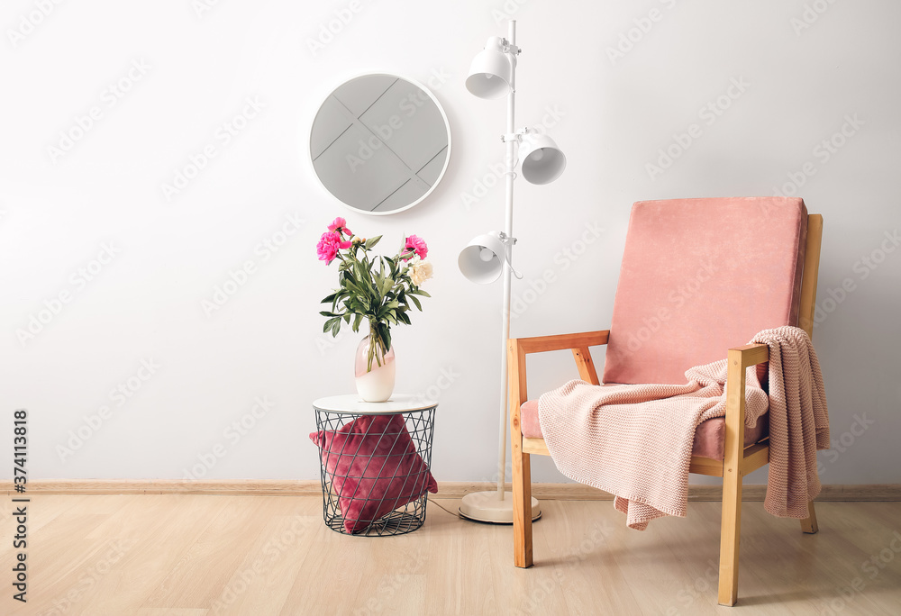 Stylish interior of room with mirror, table and armchair