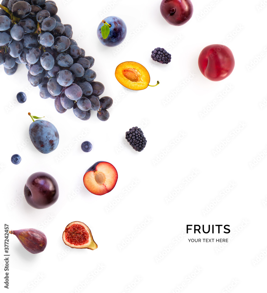 Creative layout made of fruits including: grapes, plums, figs, blueberries and blackberries on the w
