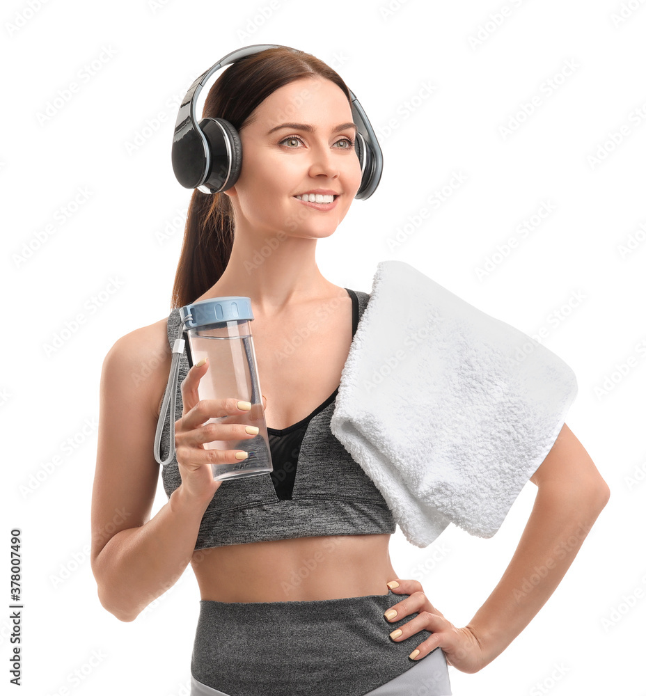Sporty young woman with bottle of water on white background