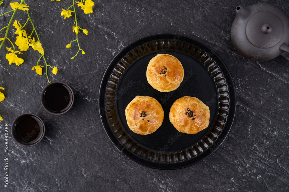 Moon cake yolk pastry, mooncake for Mid-Autumn Festival holiday, top view design concept on dark woo