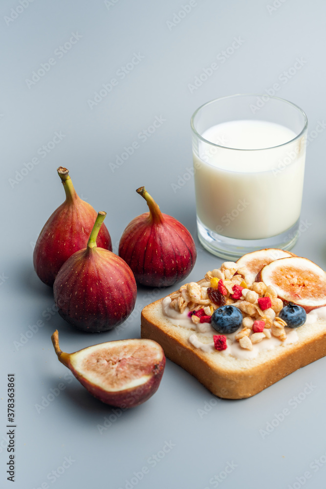 A healthy western breakfast with figs and toast and oatmeal.A western breakfast with fruit and milk