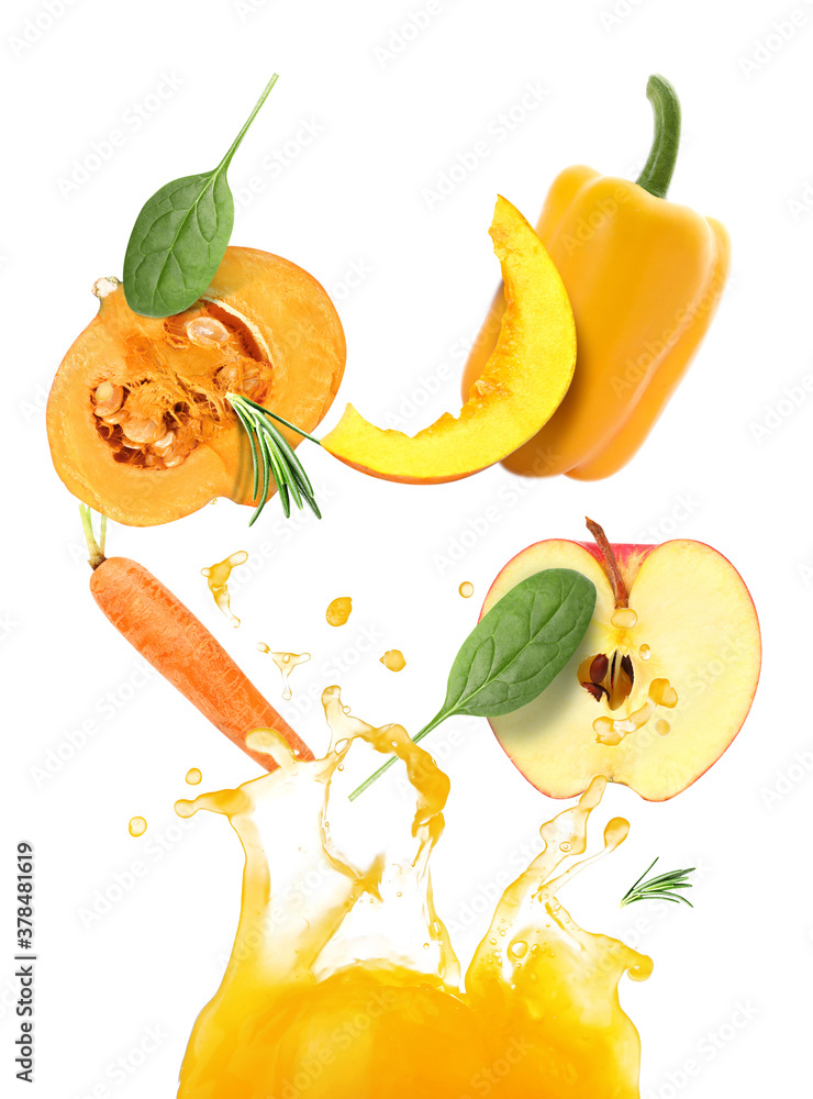 Splash of fresh vegetable juice and flying ingredients on white background