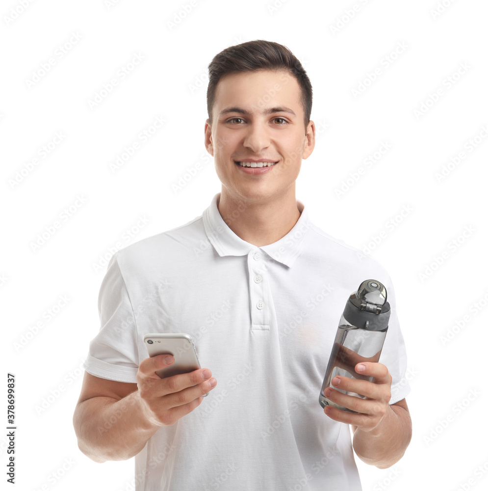 Young man with bottle of water and mobile phone on white background