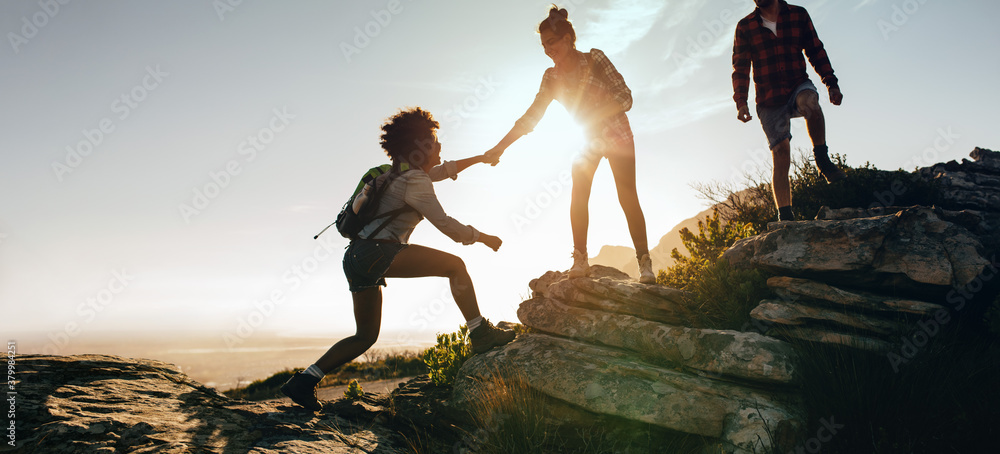 Helping each other hike up a mountain