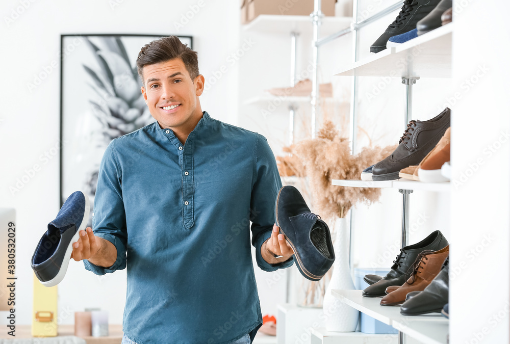 Man choosing new shoes in modern store