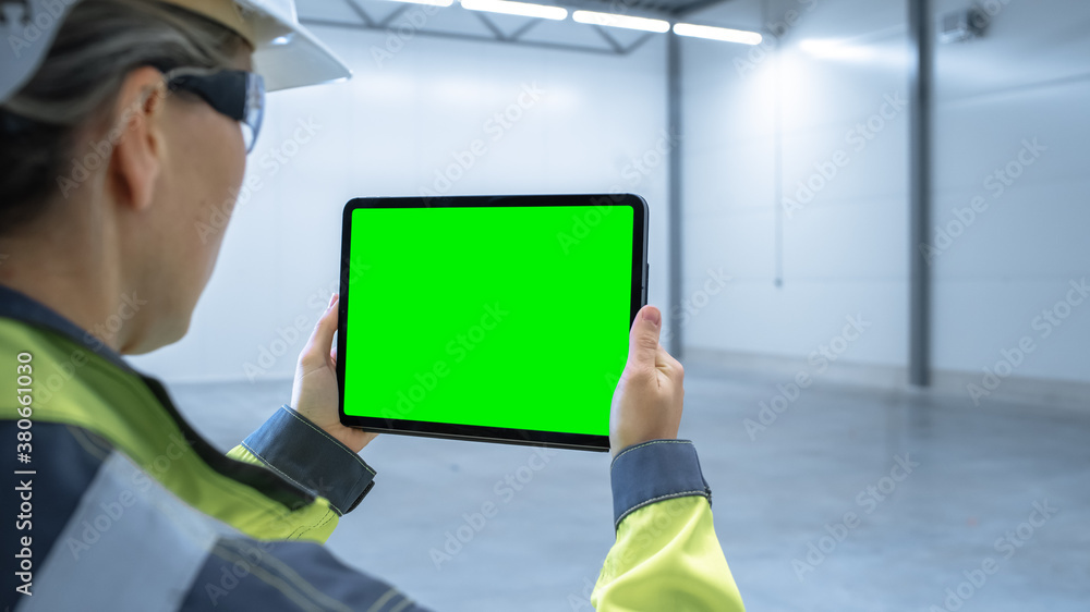 Industry 4.0 Modern Factory: Female Engineer Uses Digital Tablet Computer with Green Screen Mock-up 