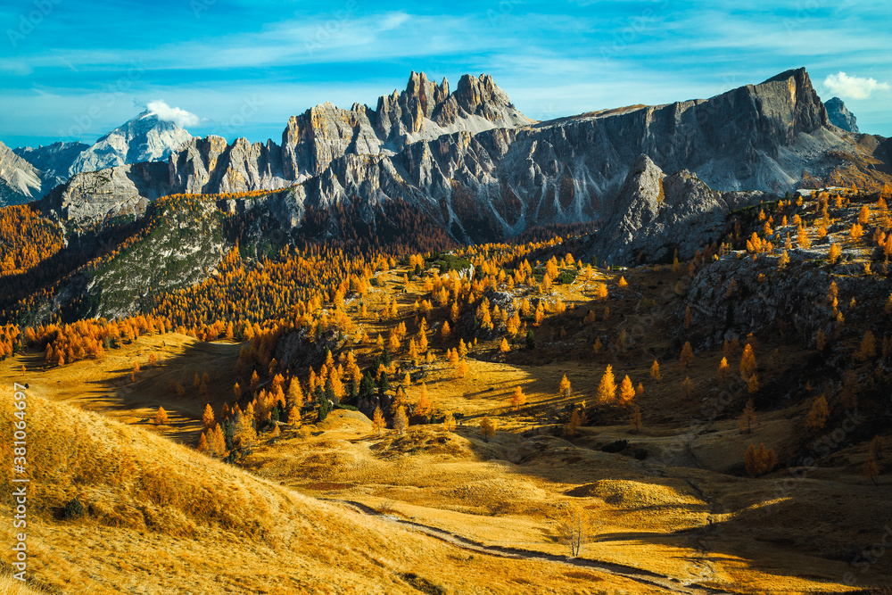 Autumn colorful larch forest scenery with beautiful mountains, Dolomites, Italy