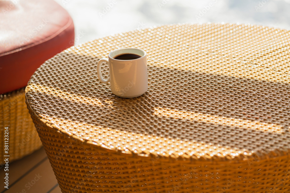 morning casual weekend with hot drink coffee on rattan table on wooden patio sunshine from window ca