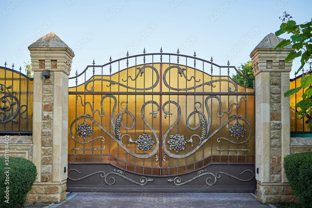 Luxury metal wrought iron gates for car entry into a private house