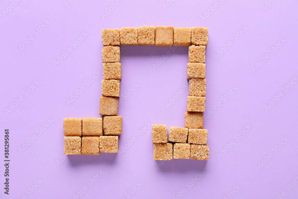 Music note made of sugar on color background