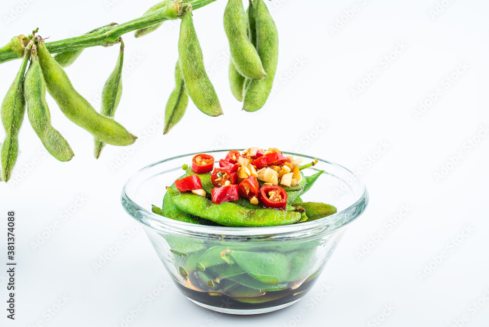 A plate of delicious cold edamame on white background