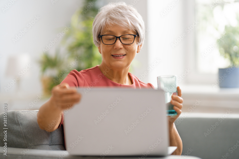 senior woman is using laptop