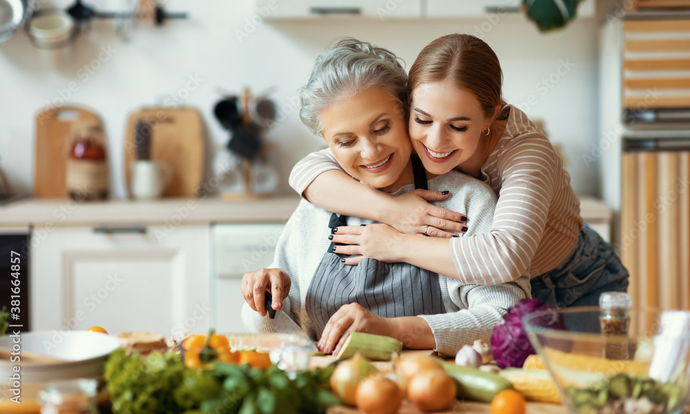 Happy mother and daughter preparing healthy food at home.