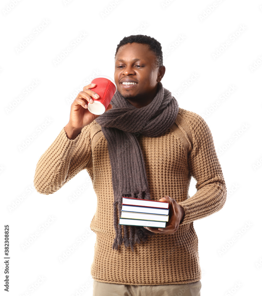 African-American man with books and coffee on white background