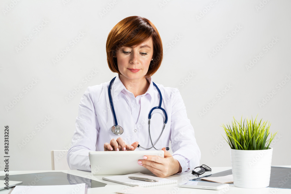 Beautiful doctor using tablet computer