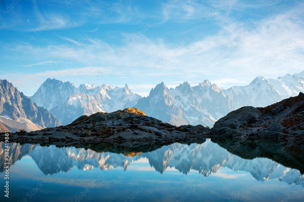 Incredible view of clear water and sky reflection on Chesery lake (Lac De Cheserys) in France Alps. 