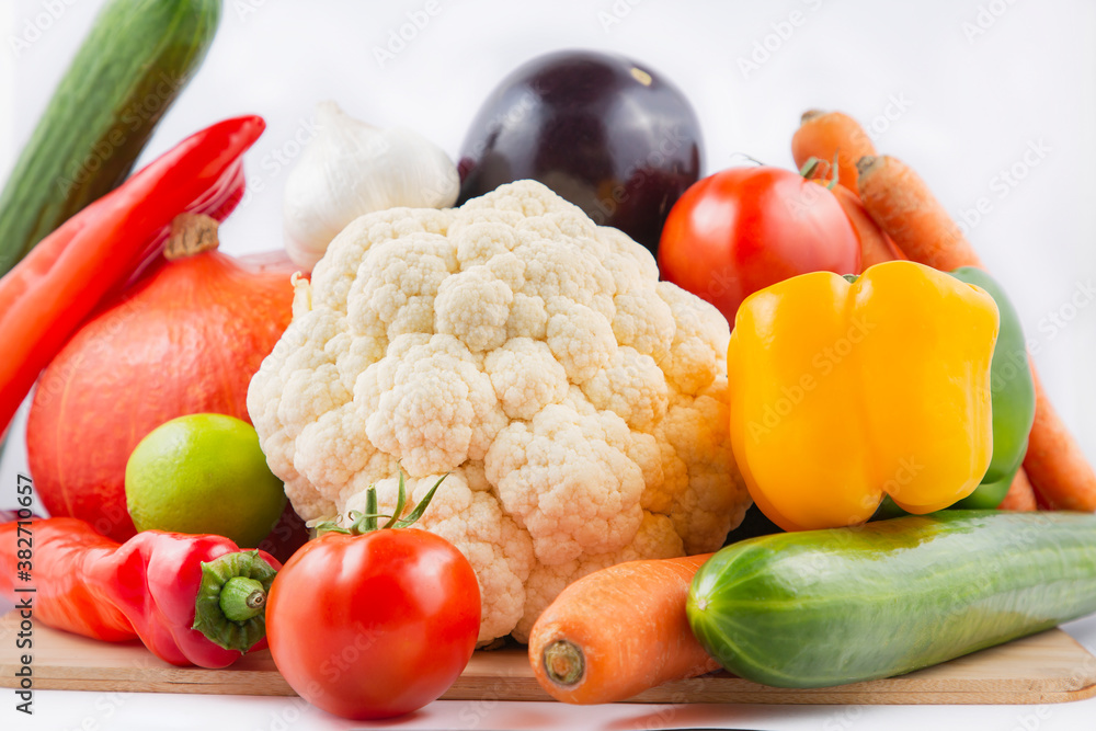 Group vegetables and Fruits Apples, bananas in a wooden basket with carrots, tomatoes, guava, chili,