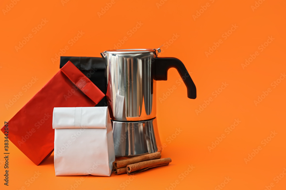 Blank bags with coffee pot and cinnamon on color background