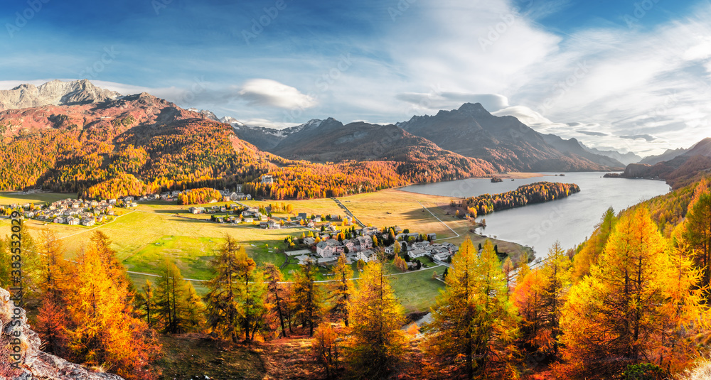 Panorama of Sils village and lake Sils (Silsersee) in Swiss Alps mountains. Colorful forest with ora
