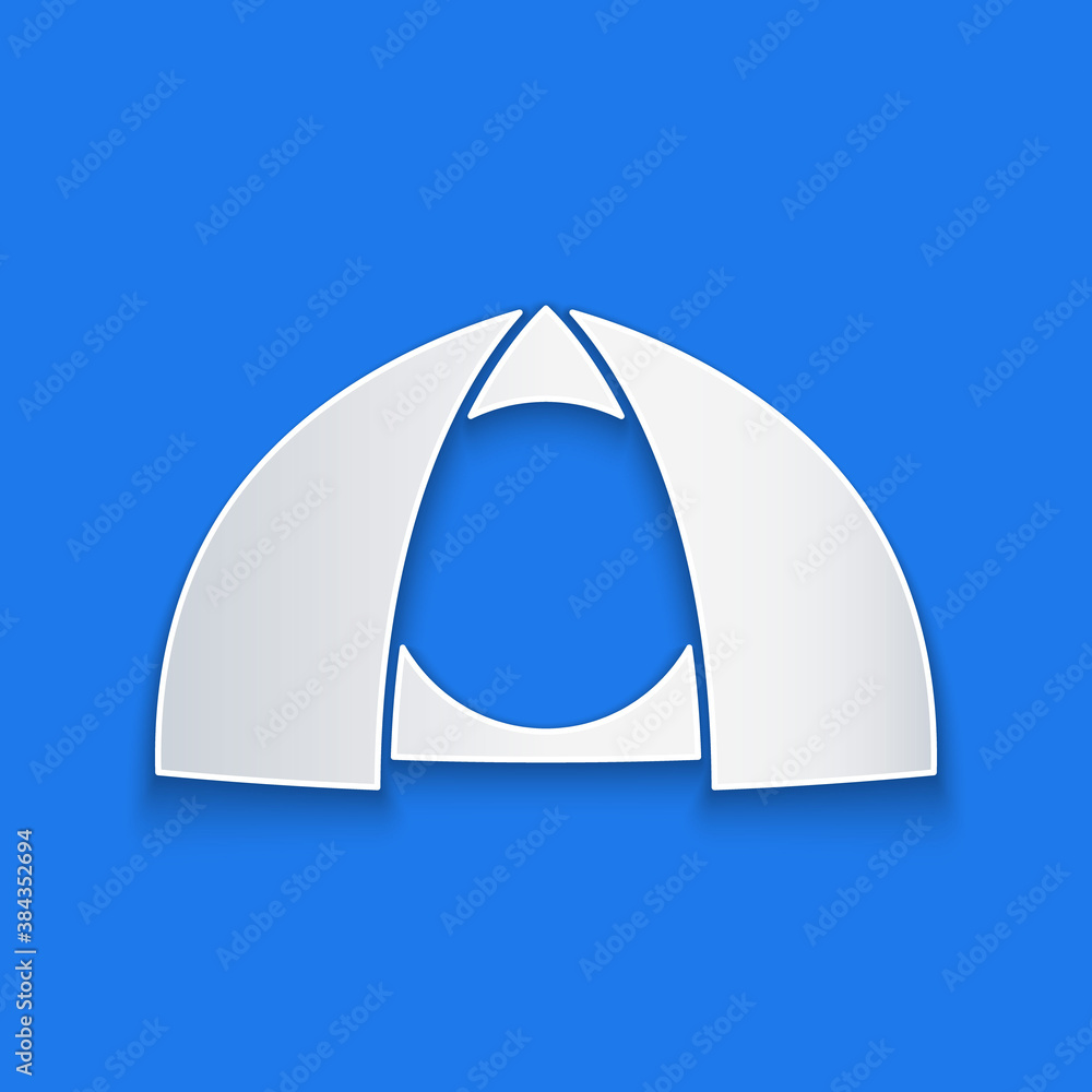 Paper cut Tourist tent icon isolated on blue background. Camping symbol. Paper art style. Vector.