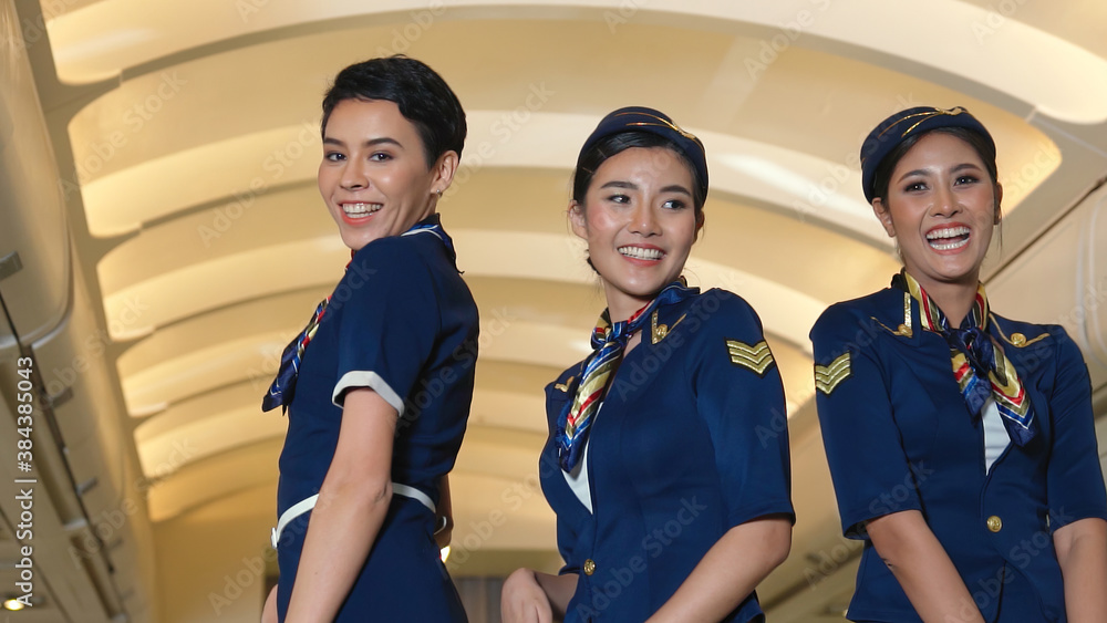 Cabin crew dancing with joy in airplane . Airline transportation and tourism concept.