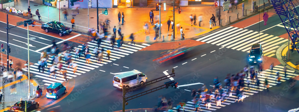 People and traffic cross the famous scramble intersection in Shibuya, Tokyo, Japan, one of the busie