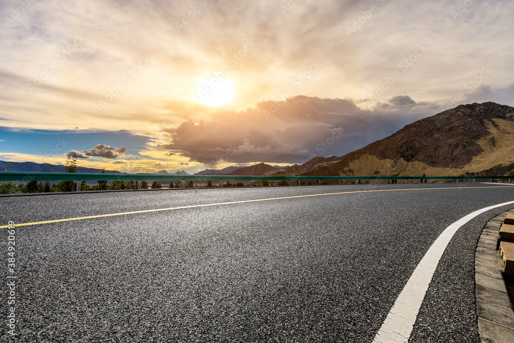 Asphalt road and mountain with sky clouds landscape at sunrise.