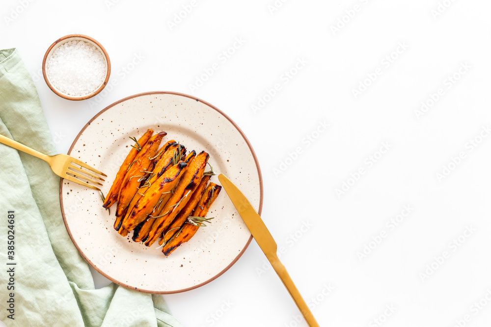 Overhead view of sweet potato fries with spices and herbs