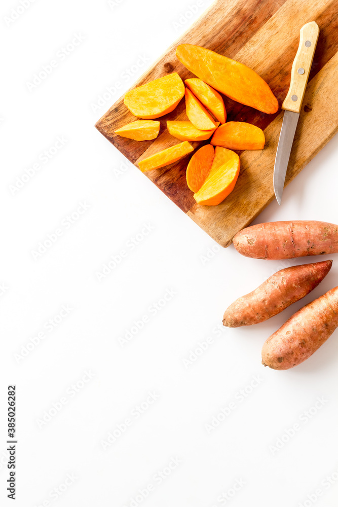 Sliced sweet potato on cutting board, top view