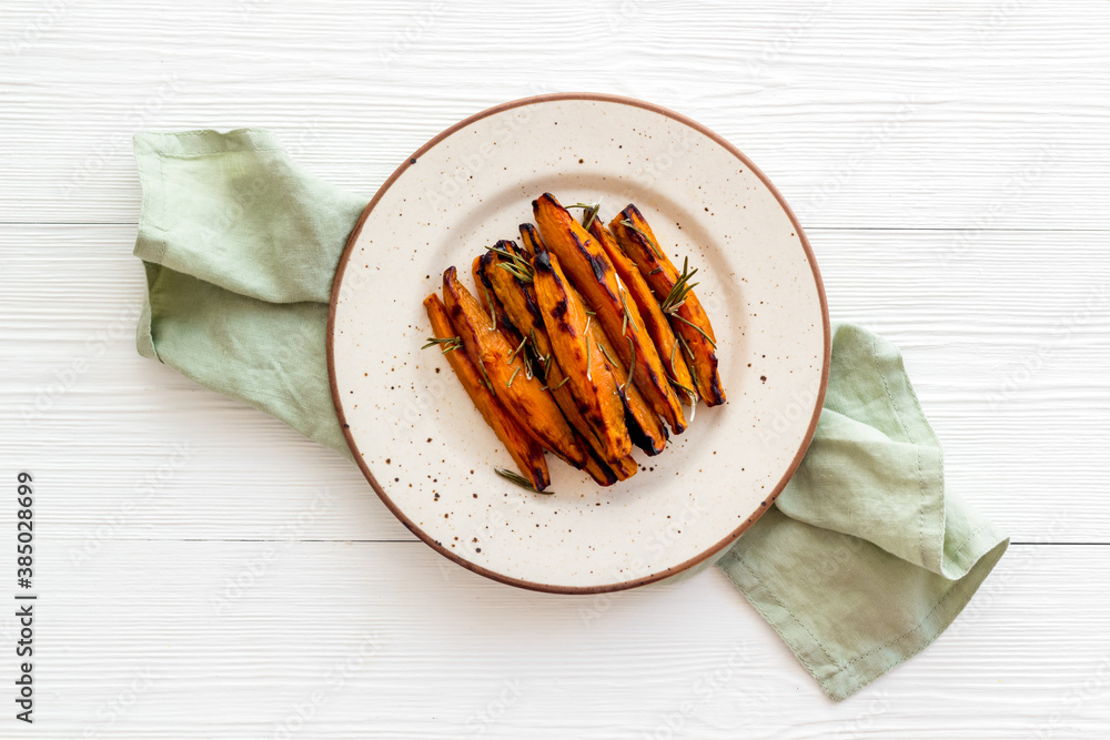 Roasted sweet potato - vegetable snack with herbs, view from above