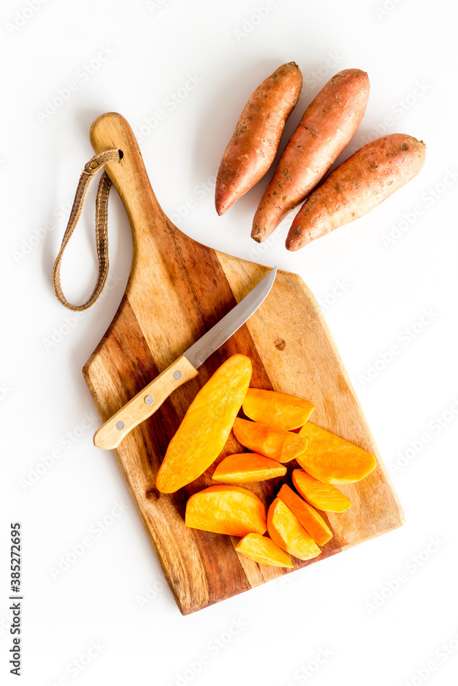 Layout of sweet potatoes. Organic vegetables background, overhead view