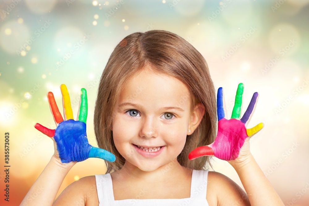 Cute little girl with colorful painted hands on  background
