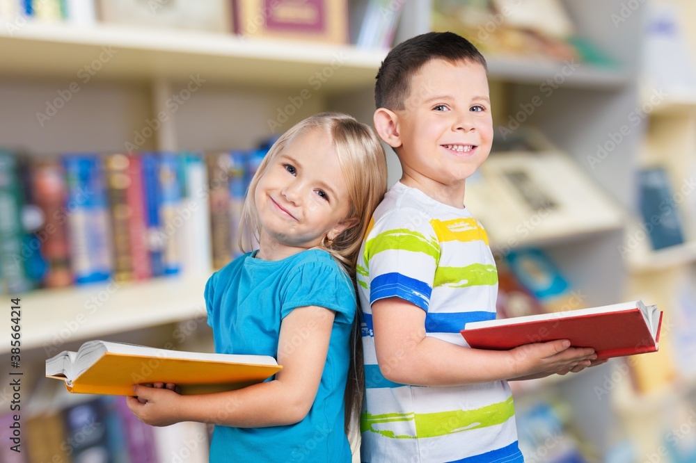 Happy smiling little boy and girl studying together