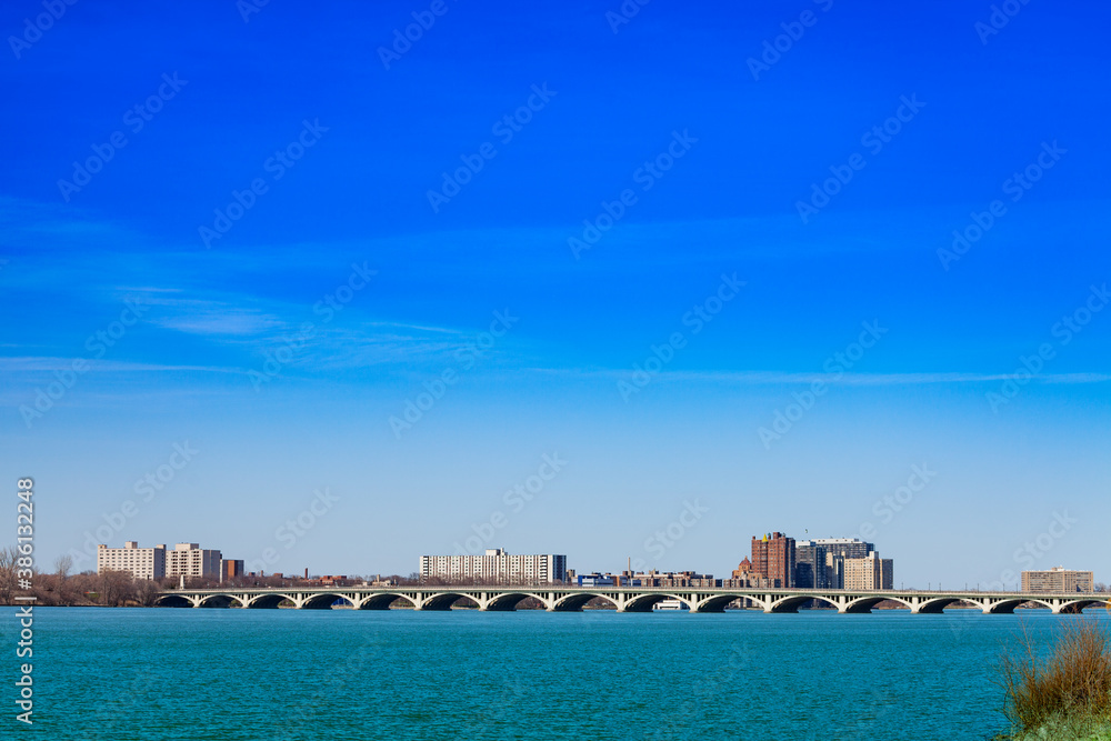 MacArthur bridge over Detroit river and city view on sunny day from sunset point of Belle Isle