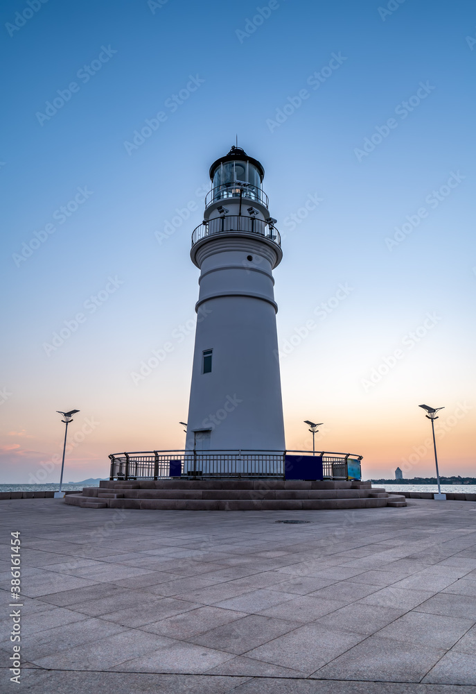 White lighthouse and urban architecture landscape night view