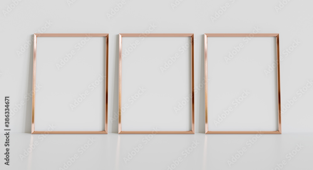 室内模型中三个金色框架靠在白色地板上。墙上的图片模板