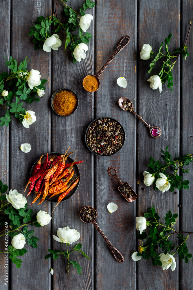 Hot spices set with herbs and flowers, top view