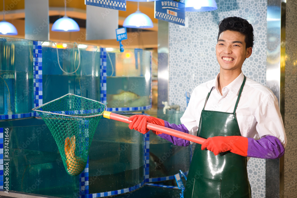 A supermarket seafood salesman with fish high quality photo