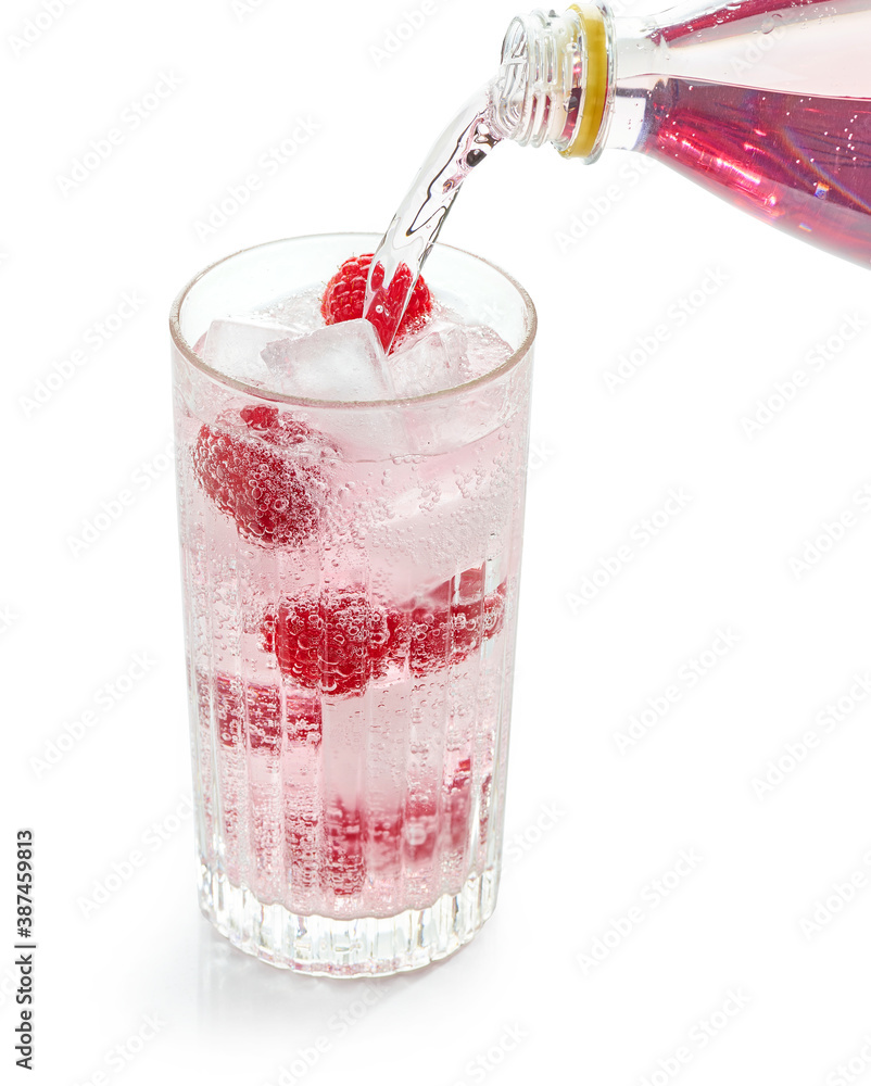pink soft drink pouring into glass