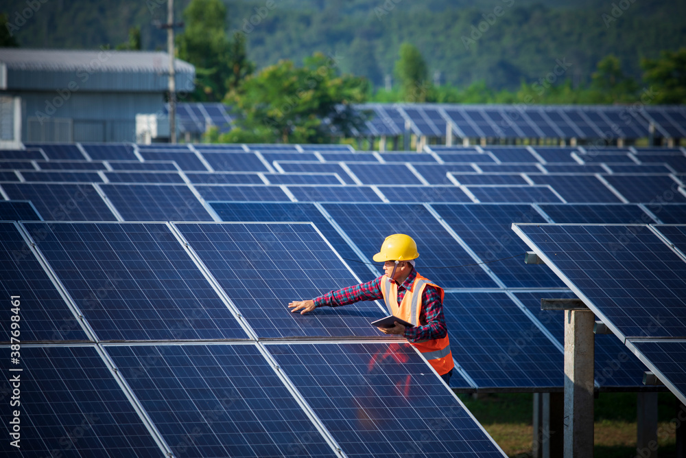 Engineers or workers are inspecting solar panels, engineers and solar power generation stations.