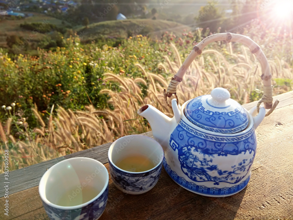 Chinese tea kettle On the wooden balcony in the morning.