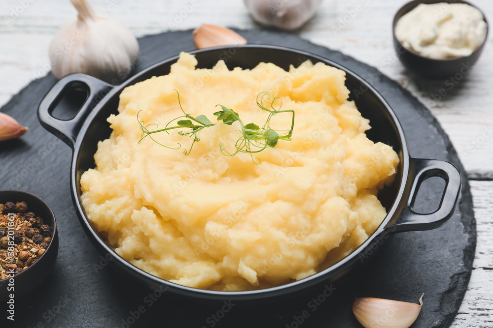 Pan with tasty mashed potato on table